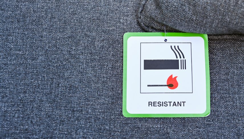 Label on the cushion of furniture showing the fabric has been treated to make it fire resistant