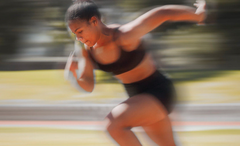 Speed, track and fast woman running for fitness health, exercise and workout for marathon race, contest or competition