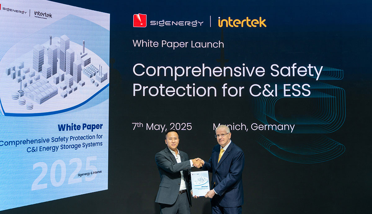 Two men shaking hands while holding whitepaper document