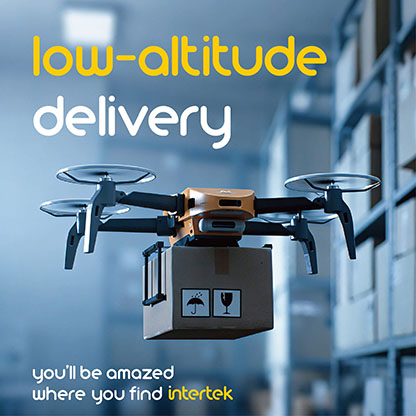 A drone carrying a package in a warehouse