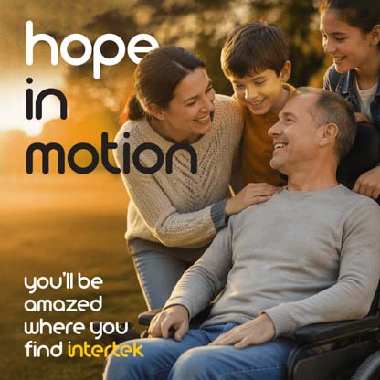 A man in a wheelchair surrounded by his family