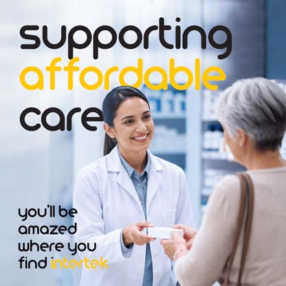A pharmacist smiling while interacting with a customer